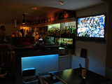 A hideaway bar in an alley. The yellow dogatee is the landmark.